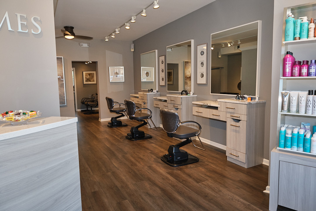 Row of styling stations and chairs at Wesley James Salon